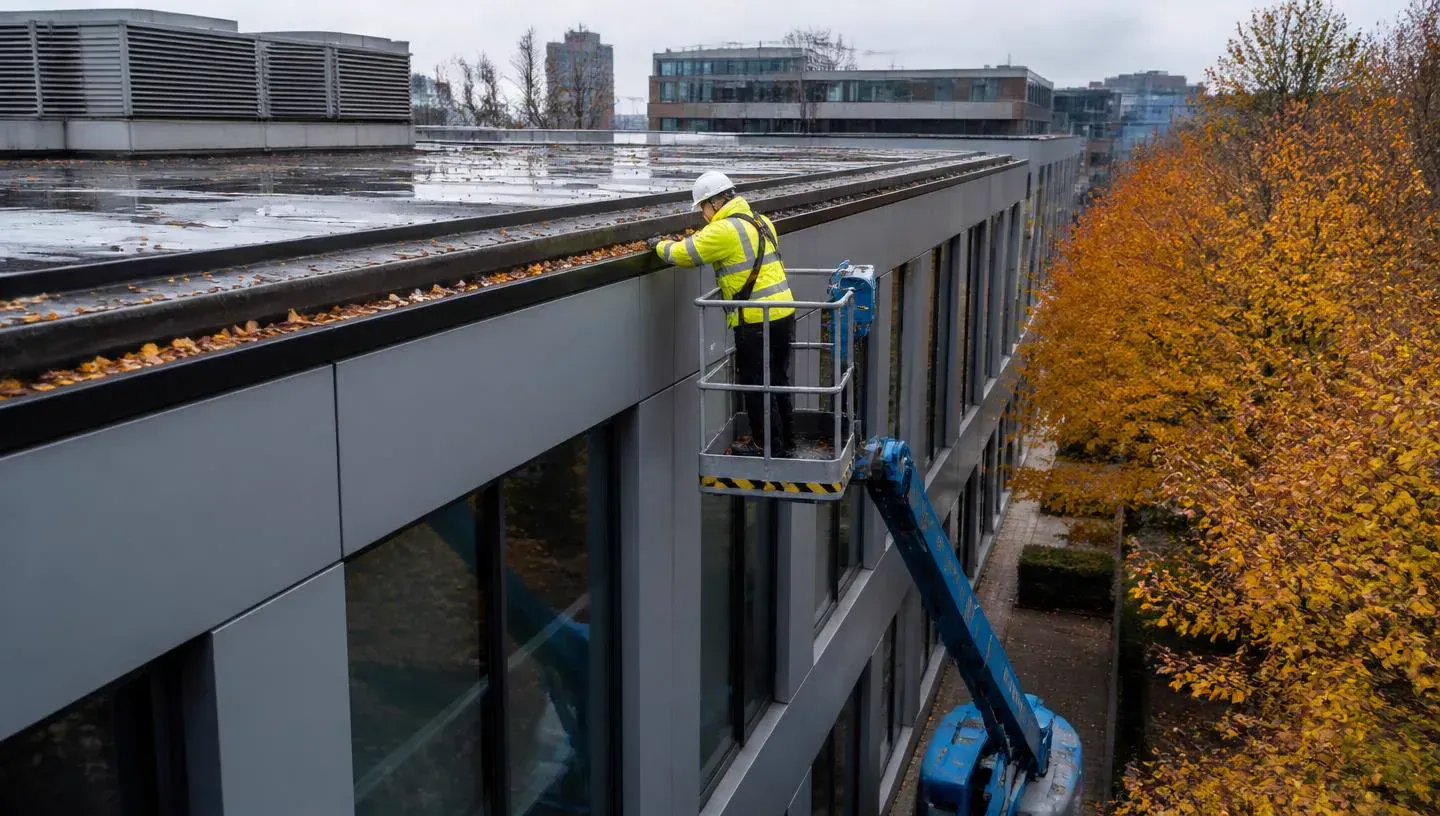 Commercial gutter clearance on a flat-roofed office building using powered access